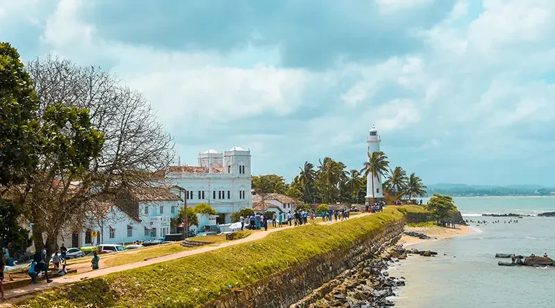 View of the white lighthouse and the historic stone ramparts of Galle Fort, one of the best things to do in Galle Fort for a scenic walk and sunset.