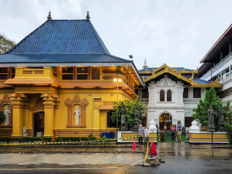 The uniquely styled yellow and white buildings of the Gangaramaya Temple, a key cultural site among things to do in Colombo.